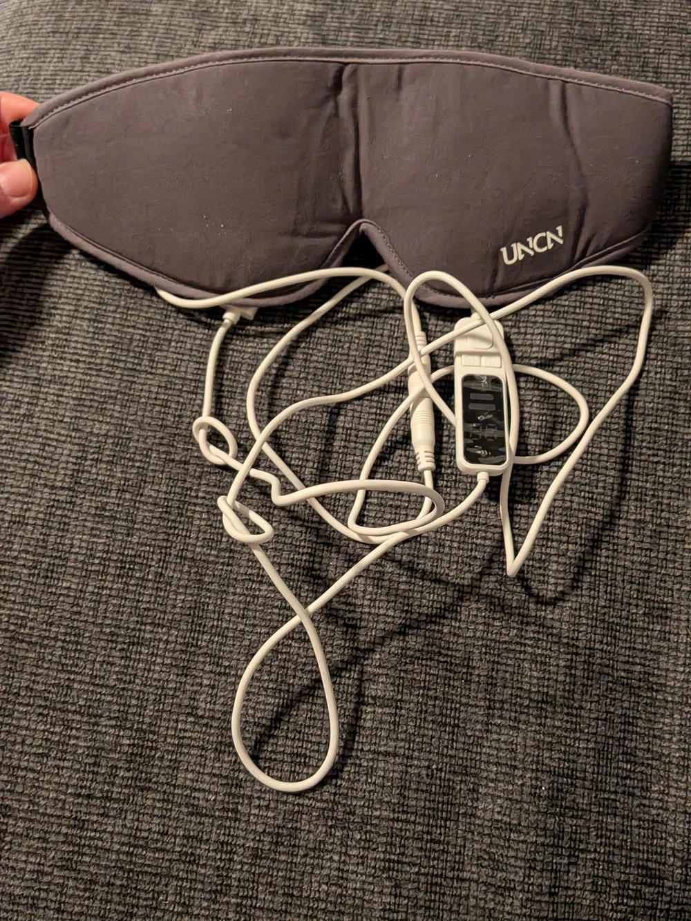 gray UNCN Heated Eye Mask featuring an attached USB cord and inline temperature/